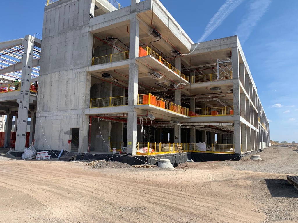 Çorlu Metamin fabrikası — çok katlı betonarme yapı, sarı güvenlik bariyerleri, sprinkler ve HVAC